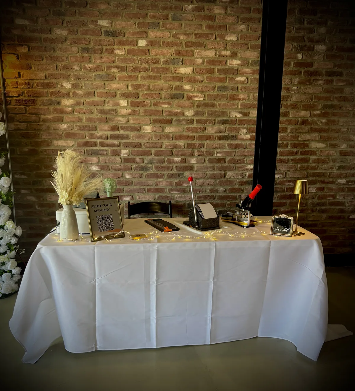 Front view of a Darling Wesley Designs display table against a brick wall